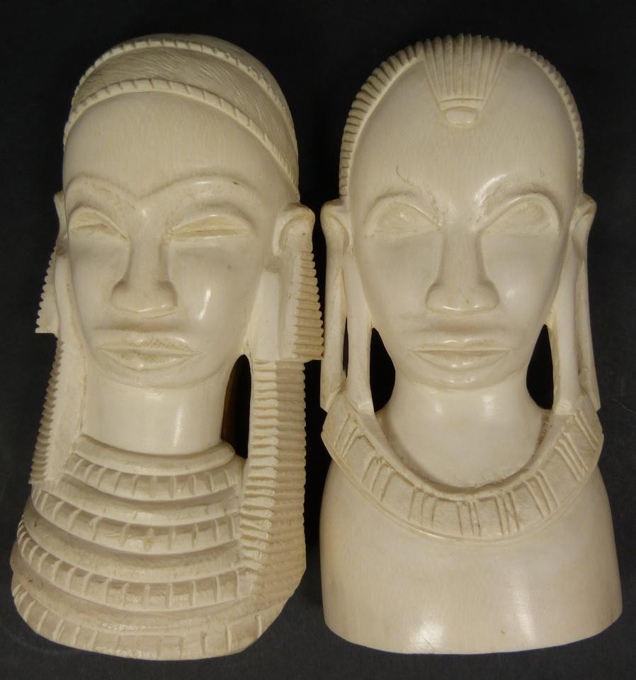 Pr OF AFRICAN IVORY WALL PLAQUE BUSTS: Pair of African ivory wall plaque busts depicting a tribal man and woman. Each approx. 7" height (17.7cm). Total weight of 1209 grams.