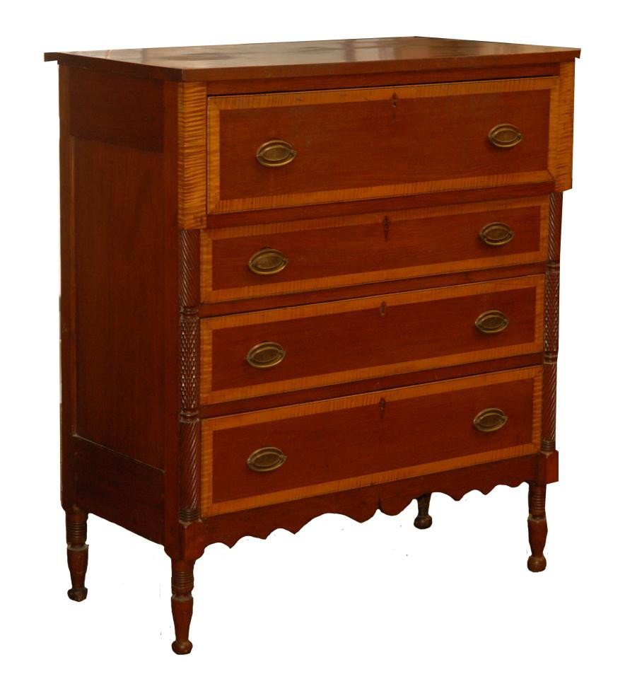 ANTIQUE 4 DRAWER LOCKING WOODEN BUREAU: Antique 4 drawer hand crafted wooden locking bureau. Each drawer had brass mounted ovoid handles with bee hive design. The two front corners of the chest of drawers is a column having a relief swirl a