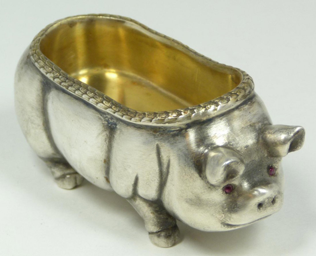 IMPERIAL RUSSIAN SILVER PIG FIGURAL SALT CELLAR: Imperial Russian silver standing pig figural salt cellar having cabochon cut ruby jewels set to eyes and gold wash to bowl. Bowl has stylized laurel leaf border design. Holds town marks and 84 silver 