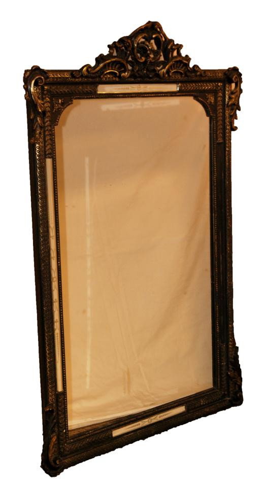 ANTIQUE EUROPEAN BEVELED GLASS WOODEN MIRROR: Antique European wooden cut mirror having beveled glass panels. Beautiful scrolled design throughout Ebonized wood with gilt overlay. 18th/19th century. Measures 59" height x 38" width (149.8cm x 96.5