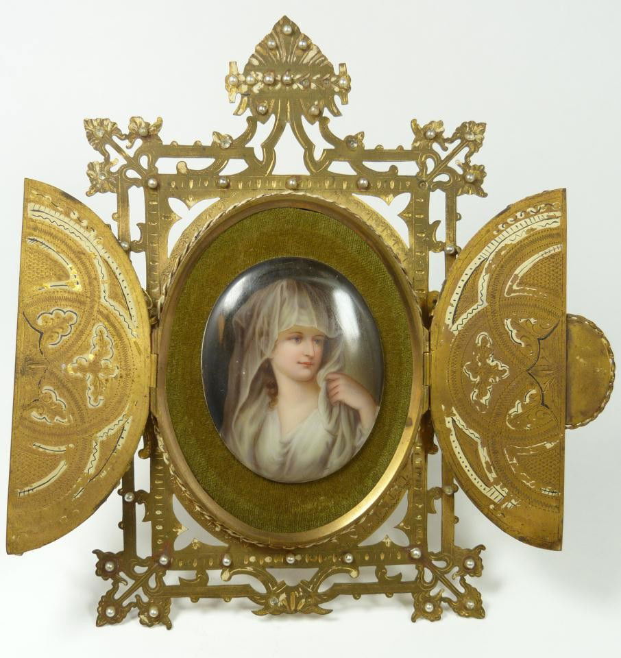 19th C KPM PORCELAIN PLAQUE IN BRASS FRAME: Antique hand painted Berlin KPM porcelain quality plaque in brass frame depicting a woman in white garb. Mounted in antique brass frame with pearls. Has miniature enameled porcelain plaque set to fron
