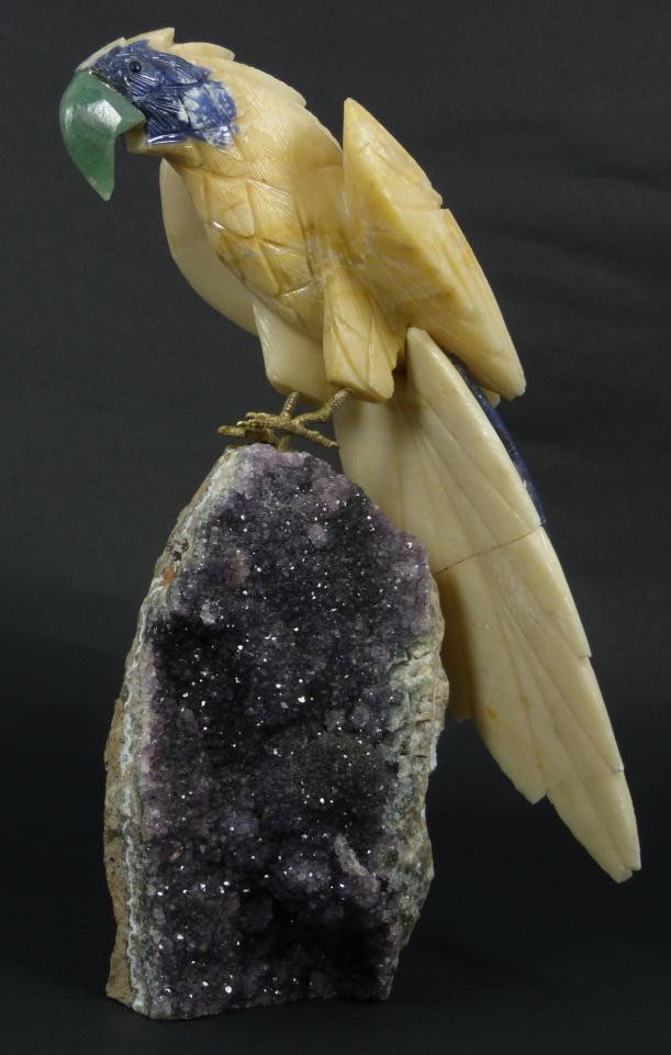 AMAZONIAN HAND CARVED STONE PARROT SCULPTURE: Hand crafted Amazon carved stone bird parrot. The bird is constructed with soapstone and lapis with bronze feet connecting to sapphire stone. Measures 13" height x 9 1/2" width (33cm x 24.1cm). Total 