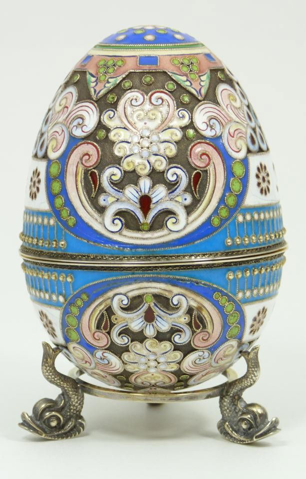 IMPERIAL RUSSIAN SILVER ENAMELED EGG OVCHINNIKOV: Russian silver enameled egg box having elegant multicolor design with B monogram. Gold wash interior. Includes stand with three figural fish feet. Piece holds Cyrillic Pavel Akimov Ovchinnikov workmas