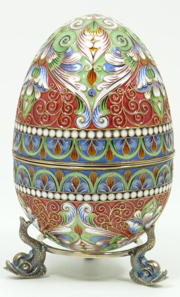 IMPERIAL RUSSIAN SILVER ENAMELED EGG: Russian silver enameled egg box having elegant scrolled floral design. Gold wash interior. Includes stand with three figural fish feet. Piece holds Faberge marks. Holds 84 silver purity mark with Mosc