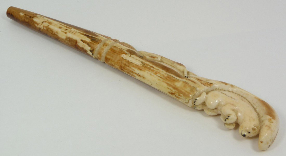 INUIT IVORY WALRUS TUSK WITH POLAR & WOLF: Hand carved Inuit hand carved ivory walrus tusk depicting a polar bear and wolf. Measures 11 3/4" length x 1 7/8" depth (29.8cm x 4.7cm). Total weight of 233 grams.