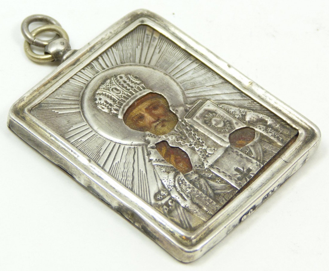 ANTIQUE RUSSIAN SILVER PERSONAL ICON PENDANT: Antique Russian silver hand painted personal icon pendant depicting religious figure St. Nicholas. Holds 84 silver purity mark with town marks and workmaster marks to bottom. 19th century. Measures 1 
