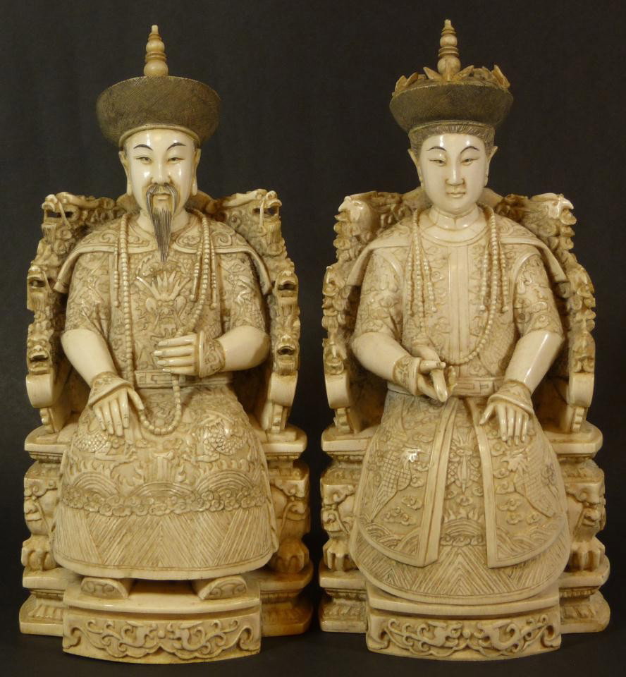Pr CHINESE IVORY SEATED EMPEROR & EMPRESS FIGURES: Pair of antique Chinese hand carved Ivory Emperor and Empress figures. Each is depicted seated on throne in royal robe. The Empress is holding Ruyi Scepter in right hand with relief carved Phoenix rob