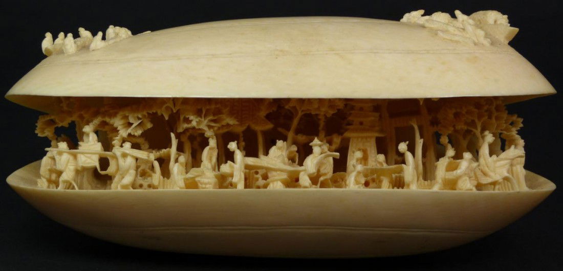 STUNNING CHINESE CARVED IVORY VILLAGE SCENE CLAM: Fully relief carved busy village scene depicting pagodas, villagers, people on horses & sedan chairs, and trees enclosed in a figural clam shell design. Top of shell depicts numerous fishermen and boa