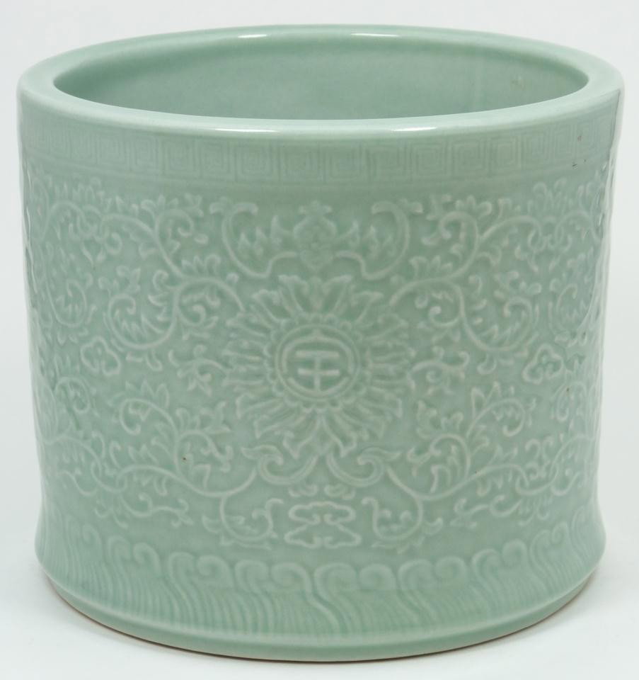 LARGE CELADON CHINESE GLAZED PORCELAIN BRUSH POT: Large celadon porcelain Chinese glazed brush holder. Heavy scroll worked carvings with 4 evenly spaced Lotus medallions with Chinese characters; this brush holder has bats above each character. Styliz