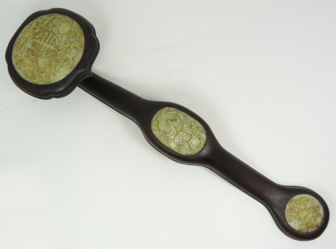 19th C WOODEN RUYI SCEPTER w JADE INLAY PLAQUES: Antique Chinese ruyi scepter w three jade panels. Each jade panel having high relief carvings depicting fans, sword, flute, double gourd, flowers and vase with flowers. 19th century. Measures 18 1/4" 