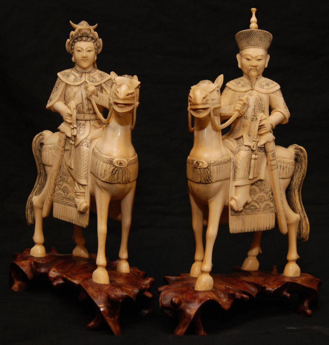 Pr OF CARVED IVORY EMPEROR & EMPRESS FIGURES: Pair of antique hand carved Chinese ivory Emperor and Empress figures. Each is depicted in full Imperial armor with ceremonial swords to hip with bows and arrow in hilt to other side. Each is sitting