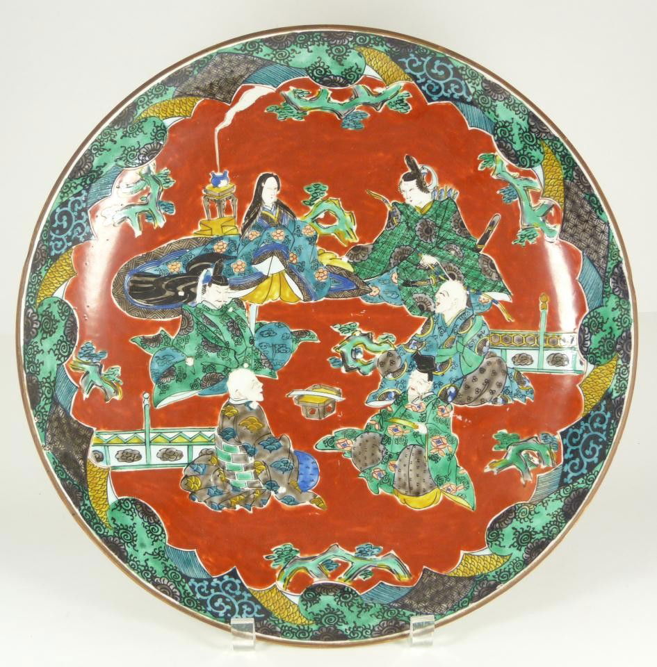 CHINESE HAND PAINTED PORCELAIN CHARGER OF SAGES: Antique Chinese hand painted enameled porcelain charger depicting 6 sages sitting in a courtyard scene. Holds red calligraphy stamp mark to bottom. Late 19th to early 20th century. Measures 14 1/4" di