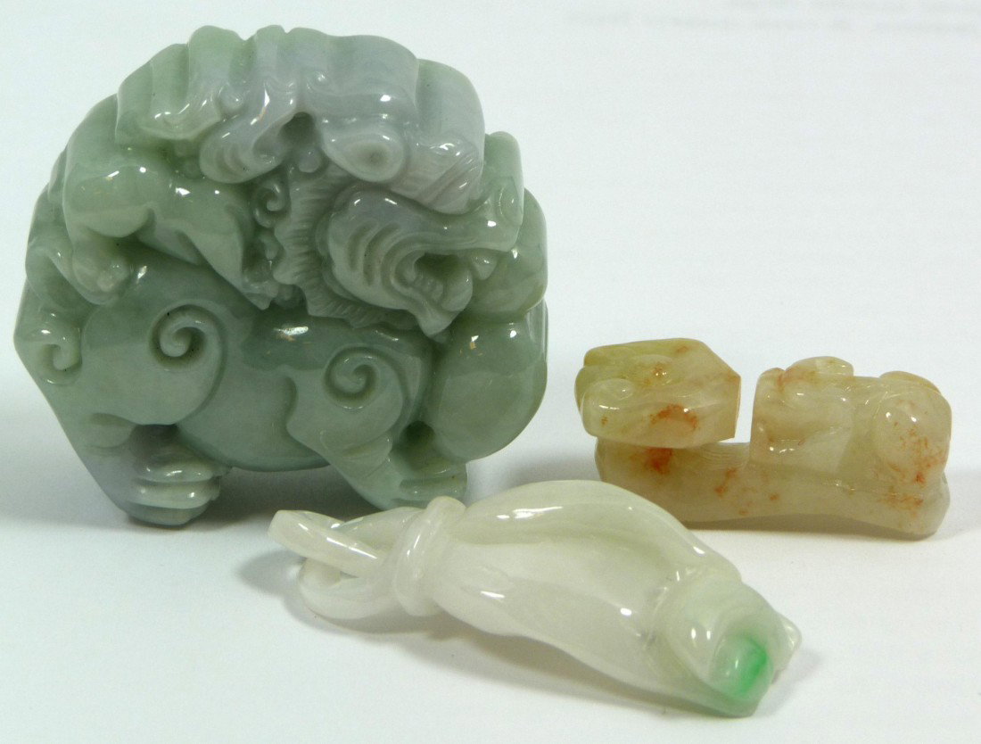 3 CHINESE CARVED JADEITE PENDANTS: 3 Chinese carved jadeite pendants including a foo dog with ball, Guan Yin hand with peach and chih lung ruyi scepter. Beautiful translucent white, russet and apple green colors. 20th century. Largest 