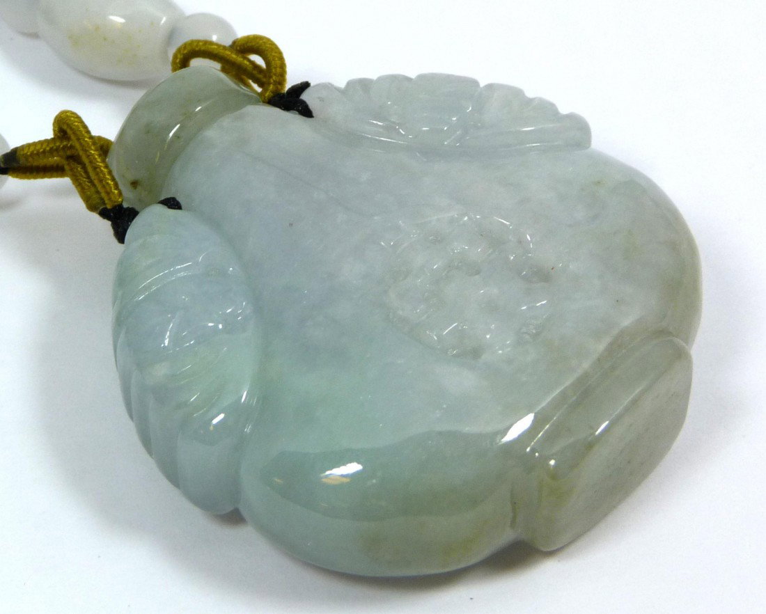 CHINESE MOTTLED JADEITE SNUFF BOTTLE PENDANT: Chinese carved jadeite mottled jadeite snuff bottle pendant with calligraphy symbols to front and back with bats to shoulders. Glowing translucent mottled white and green jadeite colors. 20th century.