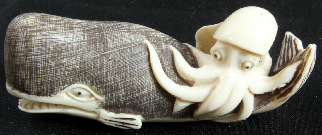JAPANESE IVORY WHALE & OCTOPUS NETSUKE SIGNED: Finely carved monochrome ivory figure depicting a a wale with octopus. Signed to bottom. Measures 2 1/2" length (6.4cm). Total weight of 24.7 grams.