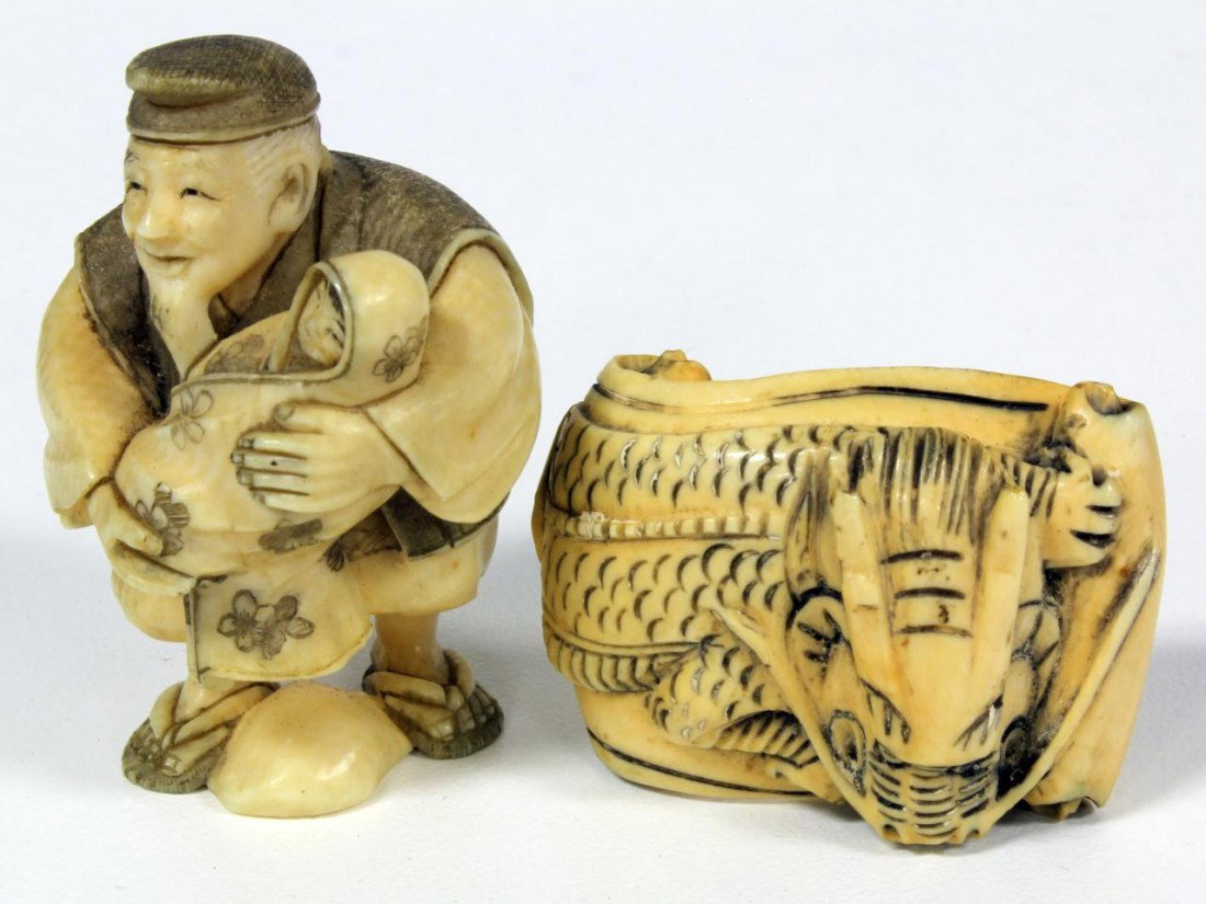 2 HAND CARVED IVORY JAPANESE NETSUKE FIGURES: 2 hand carved Japanese ivory netsuke figures figure depicting a dragon on scroll and old man with baby. Each signed to bottom. 19th century. Approx. 2" (5cm).