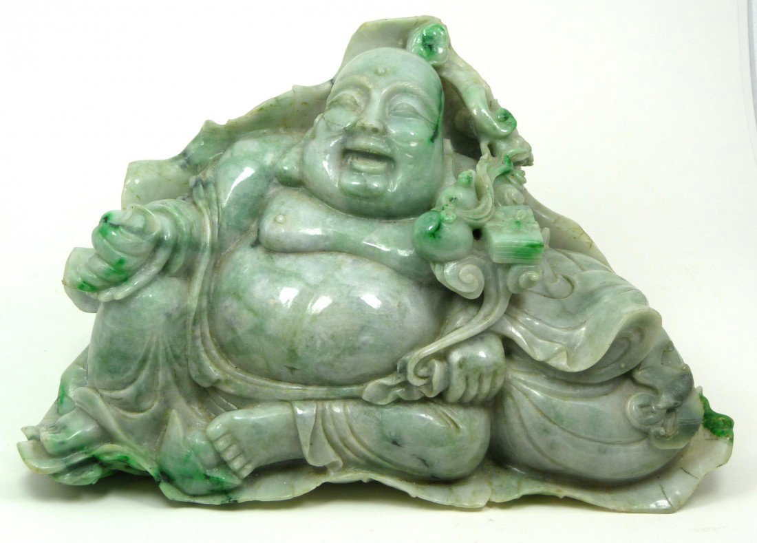 CHINESE CARVED JADEITE SITTING BUDDHA FIGURE: Finely carved heavy jadeite figure depicting a happy sitting Buddha with double gourd, bag, shell, Ruyi scepter, box, bat and coin. Beautiful translucence to jade. Measures 7 1/4" height x 13 1/4" wid