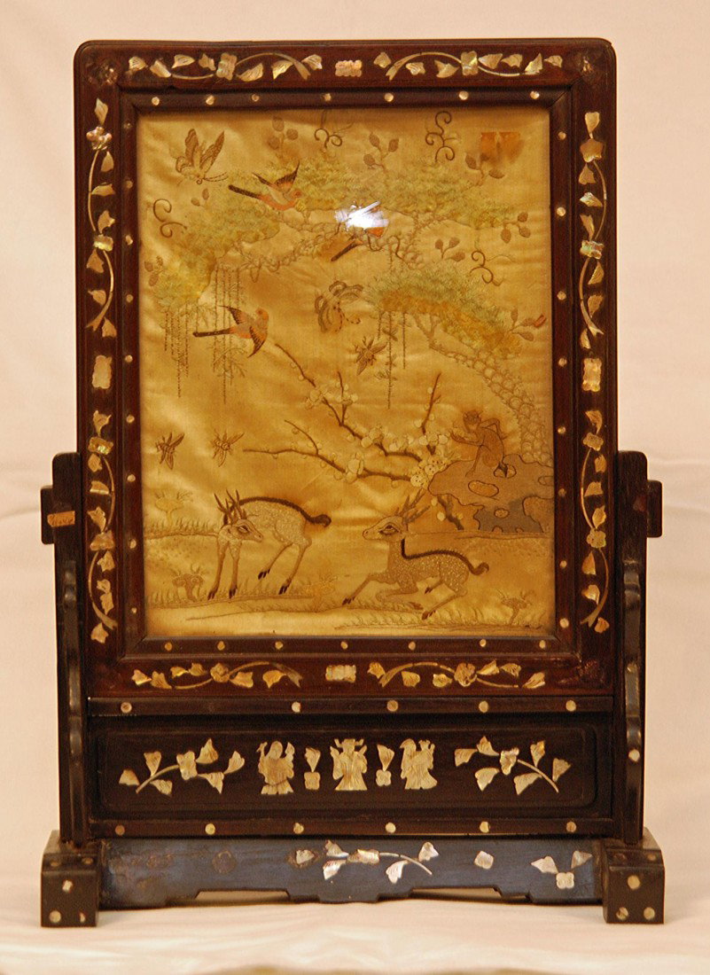 CHINESE HAND EMBROIDERED SILK SCREEN: Antique Chinese hand embroidered silk screen depicting deer, monkey, butterflies, insects, flowers, trees and paradise birds. Mounted in wooden table screen frame with mother of pearl inlay design thr