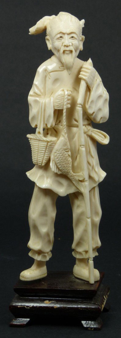 19th CENTURY CHINESE IVORY FISHERMAN FIGURE: Antique Chinese hand carved ivory fisherman figure. He is depicted with fish and basket to right hand. In his left hand he is holding a bamboo fishing pole. Mounted to wooden base. Measures 6 5/8" hei
