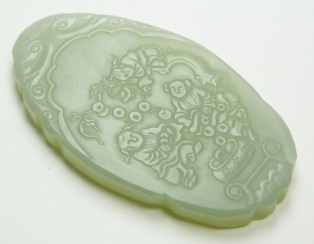CHINESE CARVED WHITE JADE PEACH HARVEST PENDANT: Fine Chinese hand carved oval white jade plaque pendant. Front depicts children gathering peaches from an abundant tree and placing them in a bowl marked Ju Bao Peng or Treasure bowl. Verso has etched