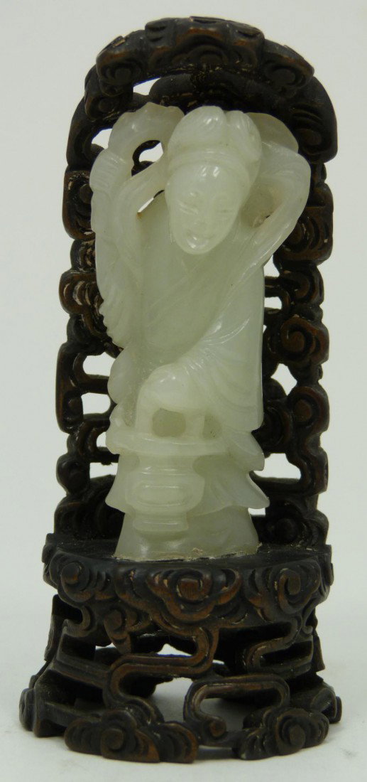 ANTIQUE IMPERIAL WHITE JADE QUAN YIN FIGURE: Antique Chinese Imperial white jade figure depicting standing female figure. Most probably Mei Jen. Includes reticulated wooden stand of cloud scroll form. 19th century. Measures 3 1/2" height (8.9cm)