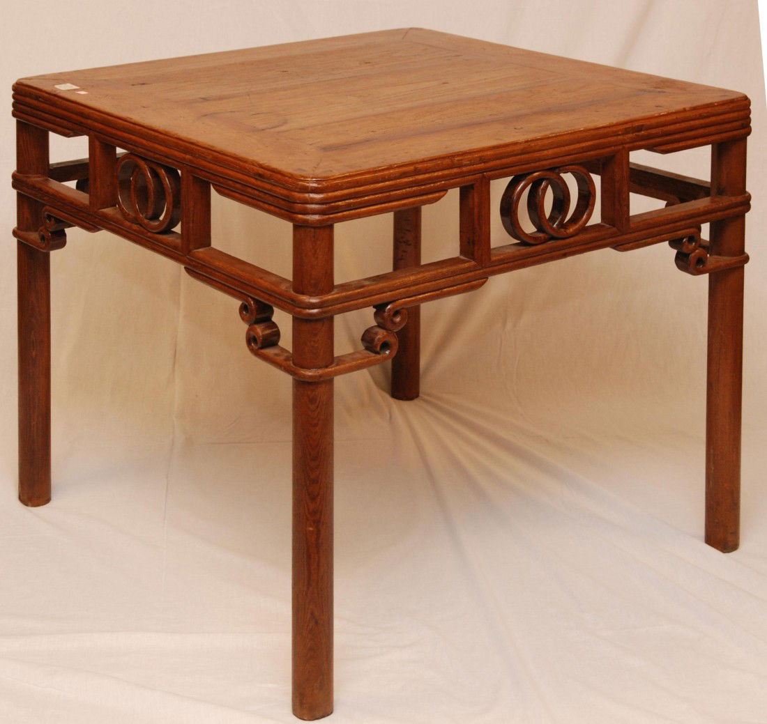 CHINESE HUANGHUALI WOOD SQUARE DINING TABLE: Chinese huanghuali wood square dining table, interlocking rings design to with four pole legs, each side united by a pierced shaped apron. 19th/20th century. Measures 32 3/4" height x 35 1/2" width x