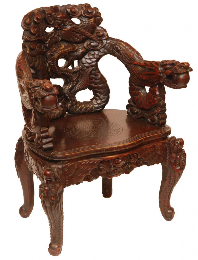 CHINESE CARVED WOODEN DRAGONS CHAIR: Chinese hand carved and fully reticulated wooden dragons chair. Has figural flying dragon back with clouds. Figural dragon with dragon jewel to mouth armrests. Relief carved and etched cloud designs t
