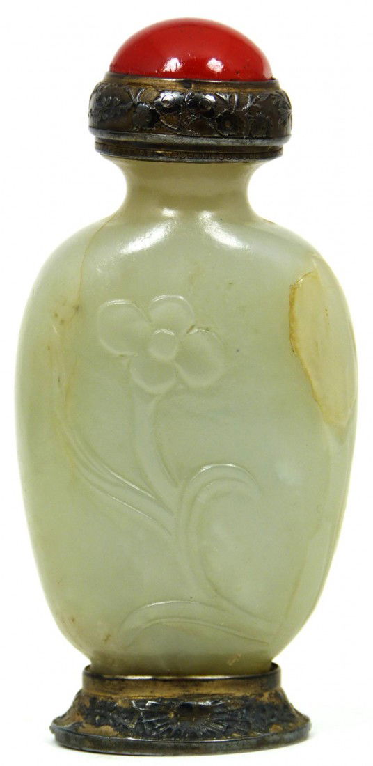 CHINESE WHITE JADE SNUFF BOTTLE w RED CORAL TOP: Antique Chinese white jade snuff bottle with high relief design depicting flowers and rock formations. Silver metal overlay to cover, rim and foot. Red coral cover. Translucent white jade color. 19th