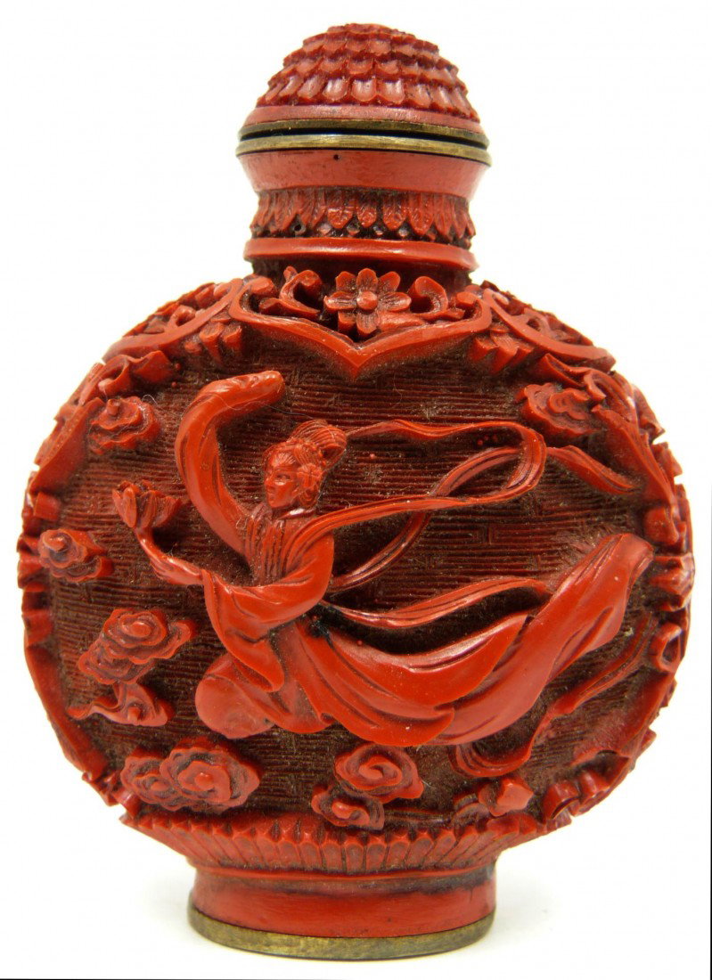 CHINESE QIANLONG CINNABAR SNUFF BOTTLE: Chinese lacquered cinnabar snuff bottle depicting flying Guan Yin to each side. Holds Qianlong (1736-1795) reign marks to bottom. Measures 2 5/8" height x 2" width (6.5cm x 5.1cm). Weight 37 grams.