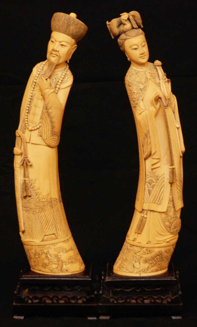 Pr. PALATIAL CHINESE IVORY EMPEROR & EMPRESS TUSKS: Pair of large Chinese hand carved ivory Emperor and Empress tusk figures. The empress is depicted holding beaded Ruyi scepter with tassel and having relief carved layered robe depicting phoenix. The e