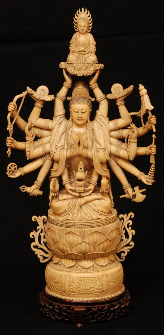 ANTIQUE CHINESE HAND CARVED IVORY 20 ARM GUAN YIN: Antique Chinese hand carved ivory 20 arm Guan Yin figure. Finely carved ivory figure depicts quan yin in layered robe with an item in each hand. Two hands are holding up a seated Buddha figure on lotu