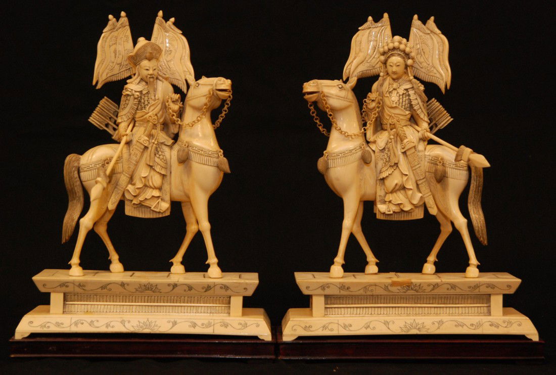 PAIR OF CHINESE IVORY EMPEROR & EMPRESS FIGURES: Pair of antique hand carved Chinese ivory Emperor and Empress figures on horseback. Each is depicted in full Imperial armor with ceremonial swords to hip with bows and arrow in hilt to other side. Eac