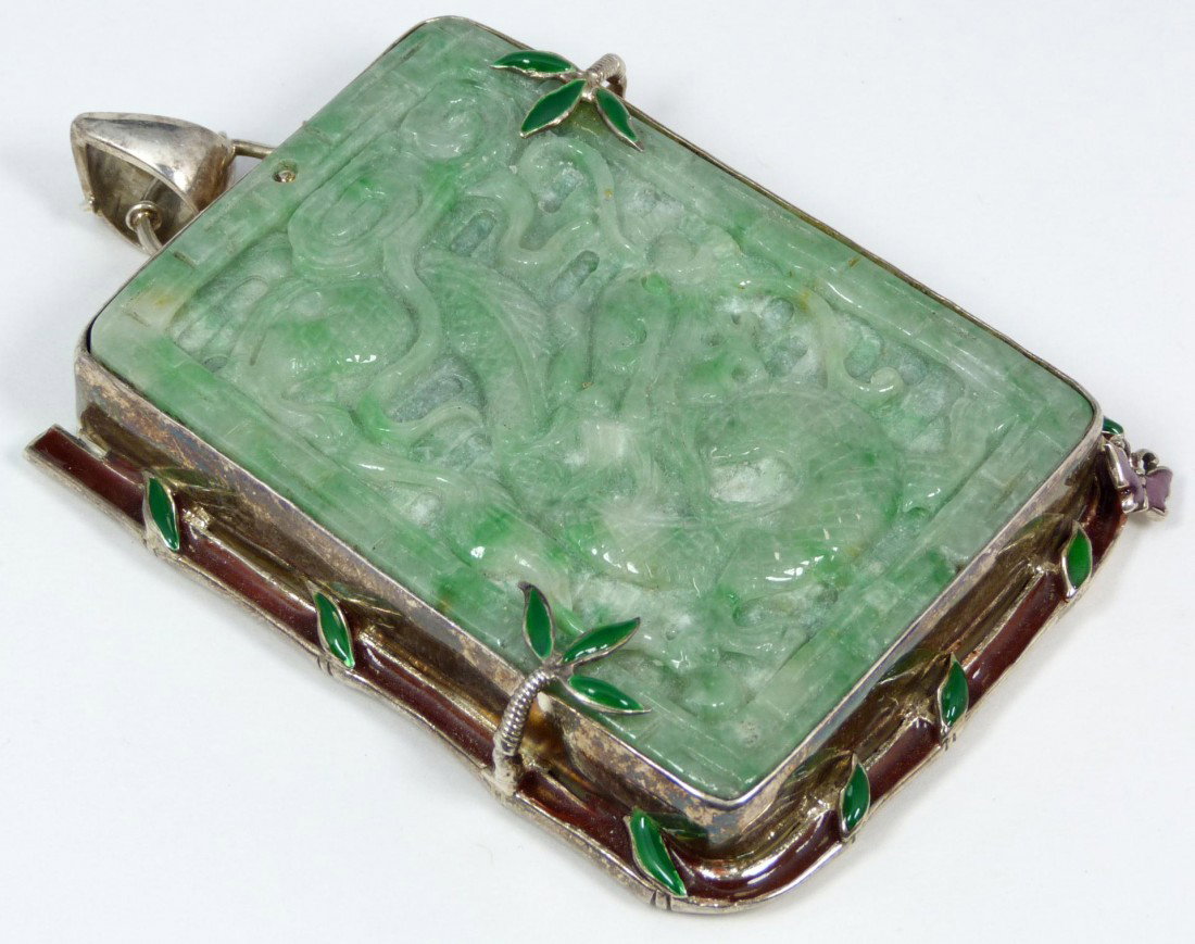 FINE ANTIQUE CHINESE JADEITE & STERLING PENDANT: Stunning large antique Chinese jadeite plaque pendant having a sterling silver frame with root form bail. Thick jadeite plaque has rectangular form with relief carved dragon design to front and lingzh