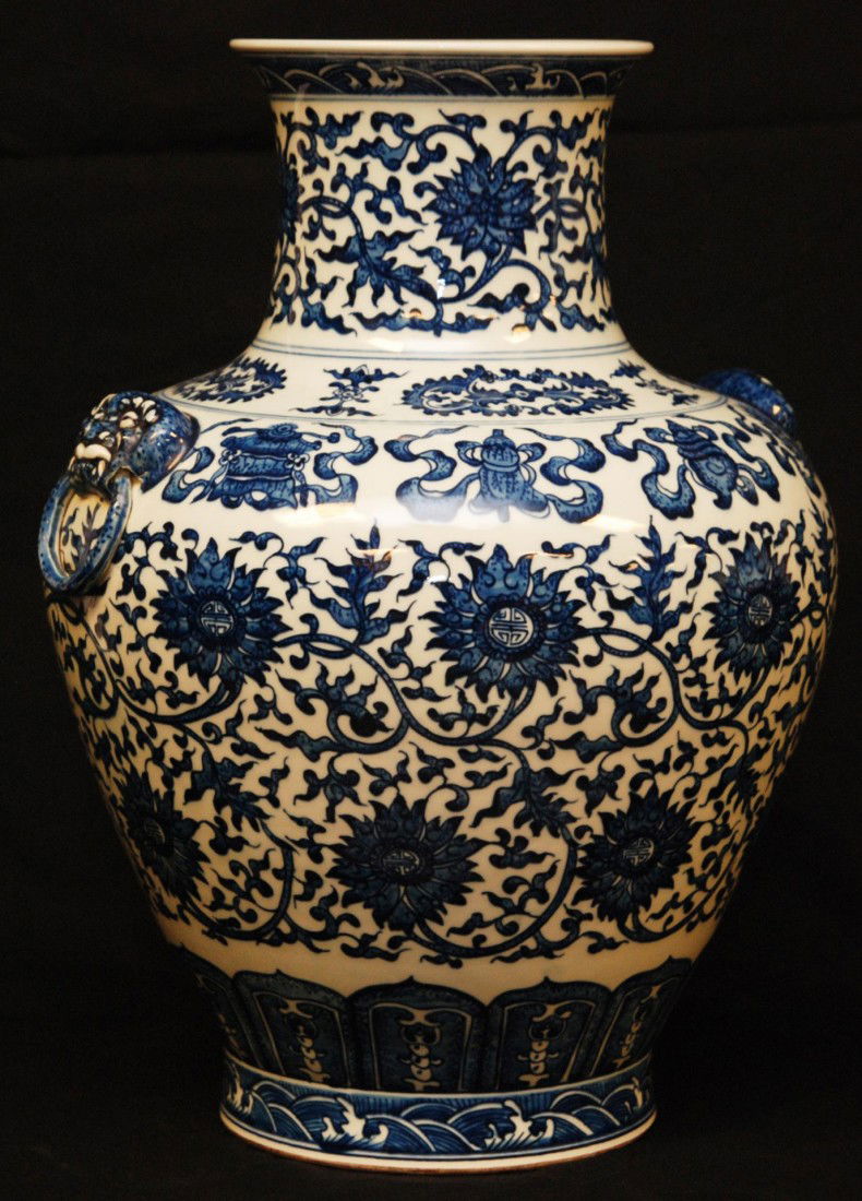 LARGE CHINESE BLUE & WHITE PORCELAIN QIANLONG VASE: Chinese Qing Dynasty blue & white hand painted Mei Ping vase. Beautiful scrolled floral design with calligraphy to center of flowers. Has fan, fish and vase bordering. Has two foo dog head with ring h