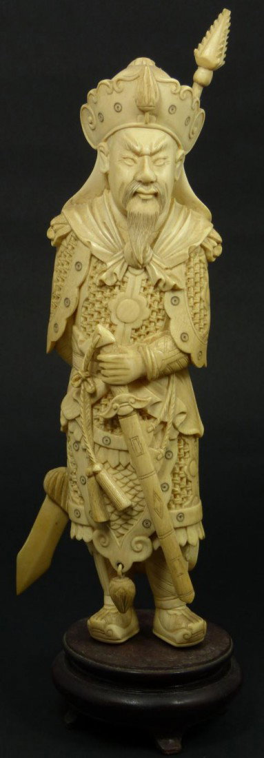 CHINESE CARVED IVORY FIGURE OF IMPERIAL SPEARSMAN: Hand carved antique Chinese ivory figure depicting an Imperial spears man. He is holding a sword by his left hip and holding spear to back with right hand. He is wearing imperial mesh armor and head d