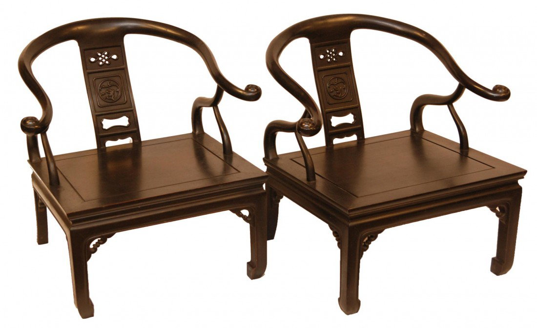 PAIR OF ELEGANT CHINESE HARDWOOD CHAIRS: Pair of old elegant Chinese Ebonized wooden chairs having a root form design to back and arms. Reticulated knot design with raised Chih lung dragon medallion design to back. Made in Hong Kong and impo