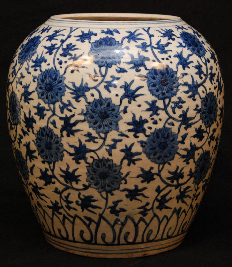 CHINESE MING DYNASTY BLUE & WHITE PORCELAIN VASE: Chinese Ming Dynasty blue & white hand painted vase. Beautiful scrolled floral lotus blossom design. Has fan, fish and vase bordering. Measures 13 5/8" height x 12 1/2" diameter (34.6cm x 31.7cm). Wei