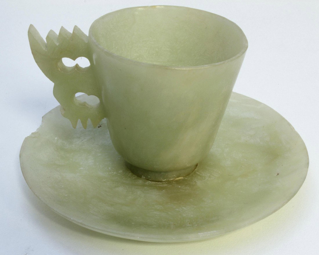 ANTIQUE CHINESE CARVED JADE CUP & SAUCER SET: Antique Chinese hand carved jade teacup with saucer. Translucent pale green jade. 19th/20th century. Cup measures 2 1/4" height (5.7cm). Saucer measures 4 3/8" diameter (11.1cm). Total weight of 164 g