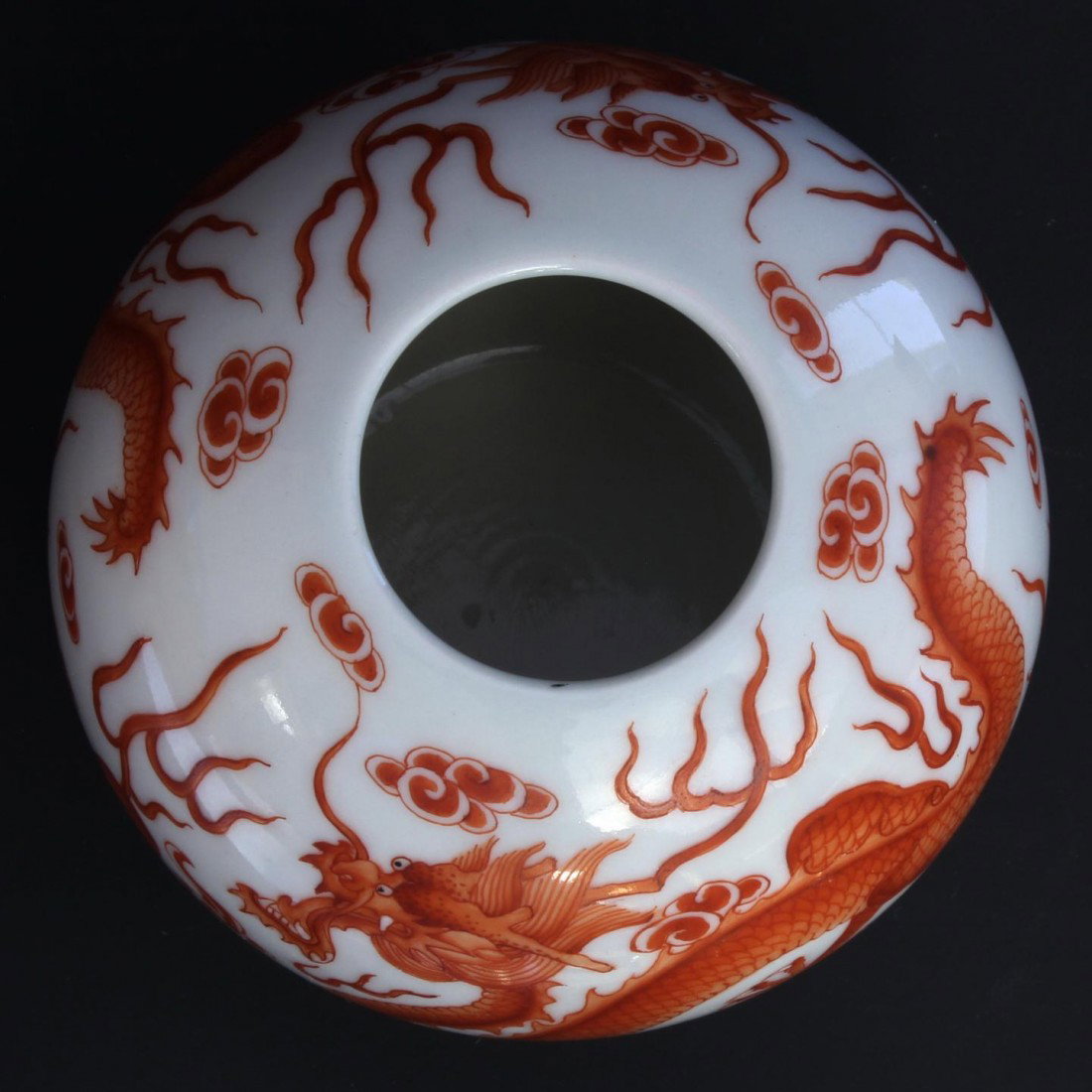 18th C CHINESE APPLE SHAPE PORCELAIN DRAGON VASE: Chinese antique apple shape hand painted porcelain vase having coral red color depicting 2 dragons with dragon jewels. Holds Qianlong (1735 - 1796) reign mark to bottom of vase. Made of the marked per