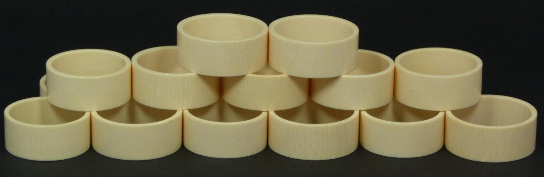 18 CHINESE CARVED IVORY ELEPHANT NAPKIN RINGS: 18 Chinese ivory napkin rings. Each approximately 1 7/8" diameter x 3/4" depth (4.7cm x 1.9cm). Total ivory weight of 220 grams.