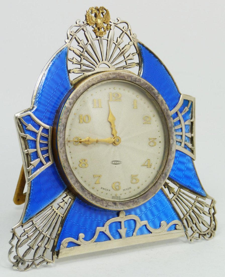 RUSSIAN SILVER GUILLOCHE CLOCK w SWISS MOVEMENT: Russian silver clock with blue guilloche enamel design. Silver face with gold numbers and notches. Has gold hour and minute hands. Has double headed eagle mounted to upper center. Holds AB 1895 Assaye