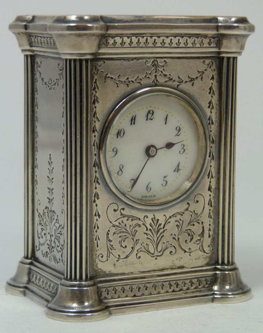 OLD WILLIAM KERR STERLING SILVER MINATURE CLOCK: Antique sterling silver miniature clock constructed by the William B. Kerr Company and having 11 Jewel Swiss movement by the Concord Wach Company and having 2 adjustments. White enamel face with black