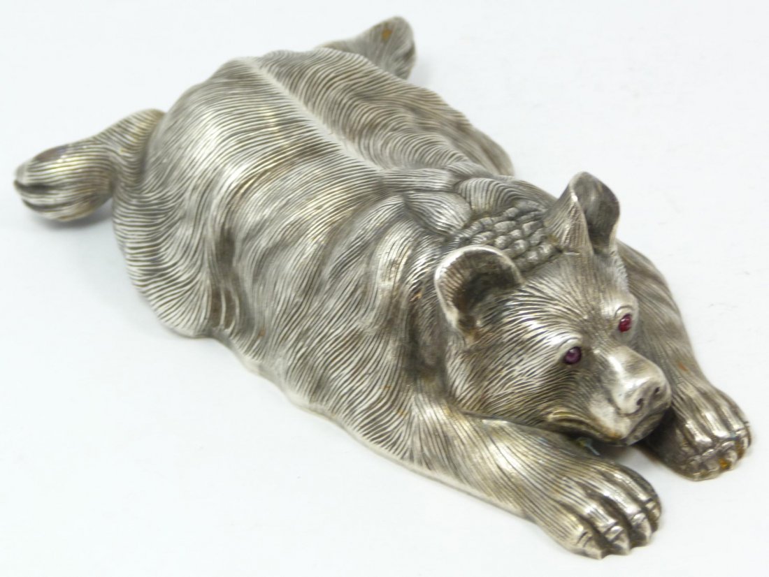 IMPERIAL RUSSIAN SILVER BEAR FIGURE RAPPOPORT: Russian silver recumbent bear figure. Cabochon cut ruby stones set to eyes. Has town marks and 84 silver purity marks to bottom. Also holds Julius Rappoport's "I.P." workmaster mark to bottom. Measure
