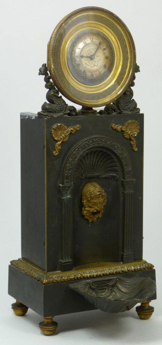 19th C EMPIRE AUTOMATION FOUNTAIN MANTEL CLOCK: Antique French Empire bronze automaton 'fountain' mantel clock. Has rectangular case with arched top and fish design. The front has a classical mask in an arched recess, on a footed plinth base and ac