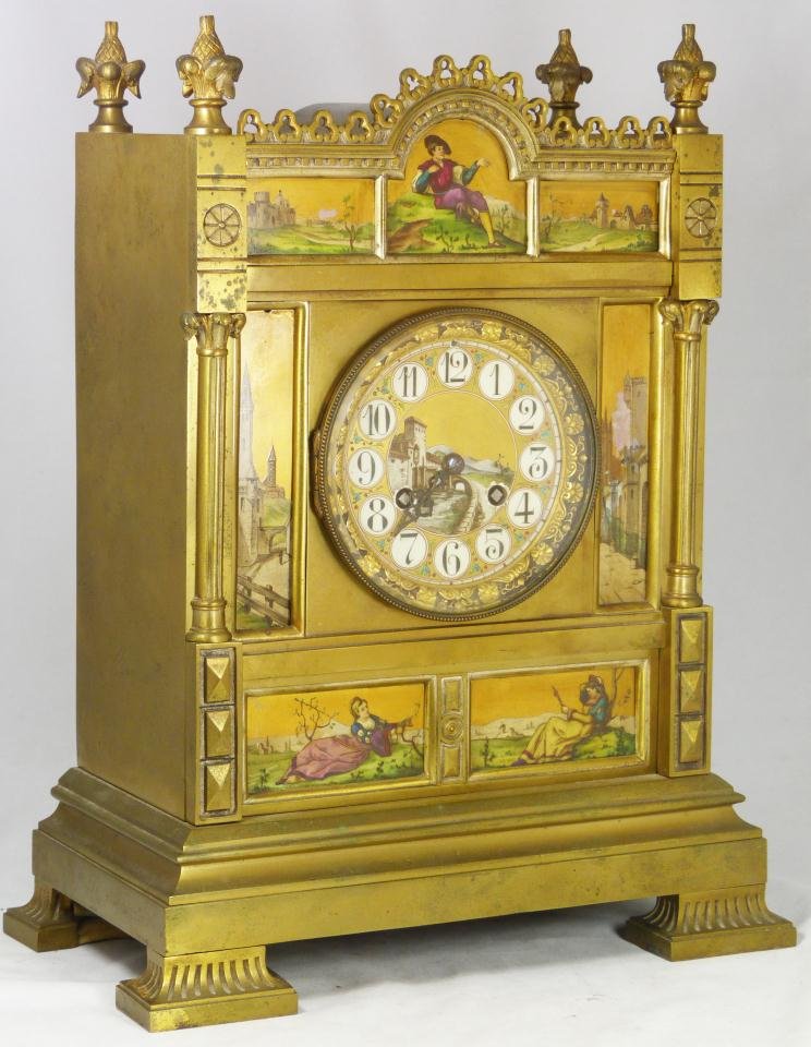 ANTIQUE EUROPEAN BRASS ENAMELED MANTLE CLOCK: Nice antique European hand painted enameled brass mantle clock. Bottom depicts two lonely females. Each from a different town. The top depicts a young man who must decide which town he going to go to 