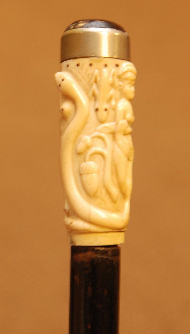 CARVED BONE HANDLE FOLK ART CANE w NUDE & ANIMALS: Antique hand carved bone folk art cane having relief design depicting nude female with monkey, bird, alligator, snake, frog and acorns. Has wooden shaft with metal tip. 19th century. Measures 35 3/4"