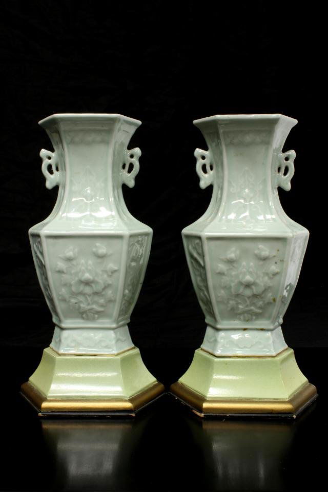 Pr CHINESE CELADON PORCELAIN FLORAL VASES: Pair of Chinese celadon porcelain vases with raised floral and scroll design. 19th century. Each set on wooden bases. Measures 8 1/2" height + 1 7/8" base height (21.6cm + 4.7cm).