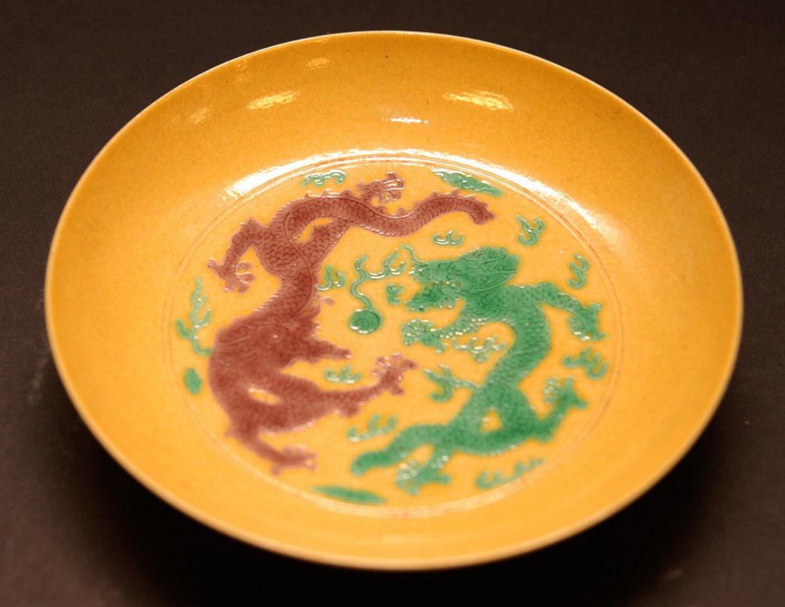 ANTIQUE CHINESE JIAQING DRAGON & CRANE SAUCE PLATE: Antique Chinese Jiaqing sauce plate bowl having a purple and green dragon design to bowl interior and four cranes with clouds to exterior all over mustard yellow ground. Holds six character archaic Ji