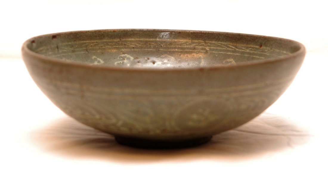 13th CENTURY KOREAN GORYEO DYNASTY CELADON BOWL: Antique and rare Korean Goryeo Dynasty celadon stoneware pottery bird bowl. The bowl is inlaid with white slip and black accents on the interior with a scene of birds flying amongst clouds. The exteri