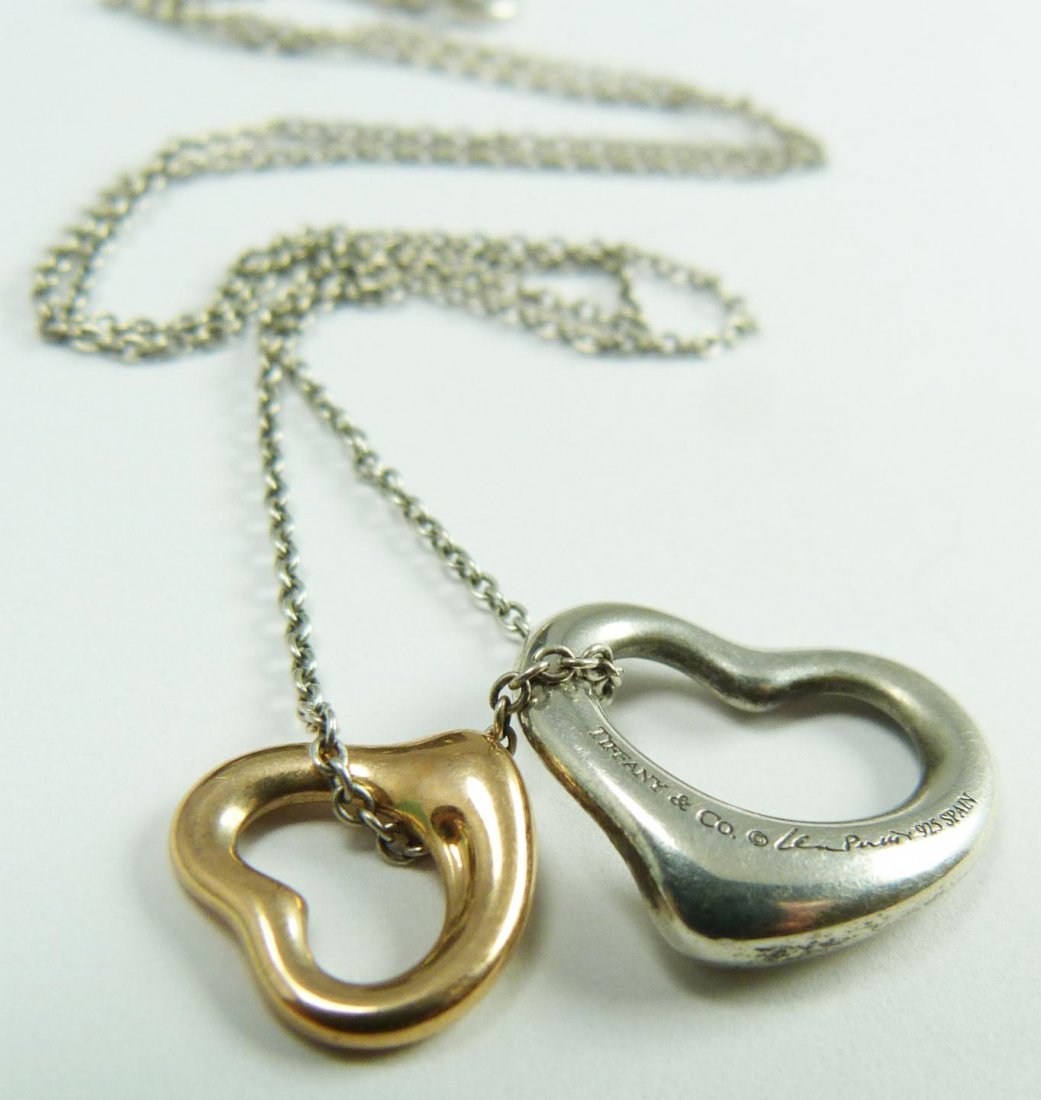 TIFFANY STERLING PERETTI NECKLACE 18K YG PENDANT: Beautiful Tiffany & Company sterling silver chain necklace with sterling silver heart pendant and 18k yellow gold heart pendant. Each piece signed Elsa Peretti. Each piece marked Spain. Includes origi